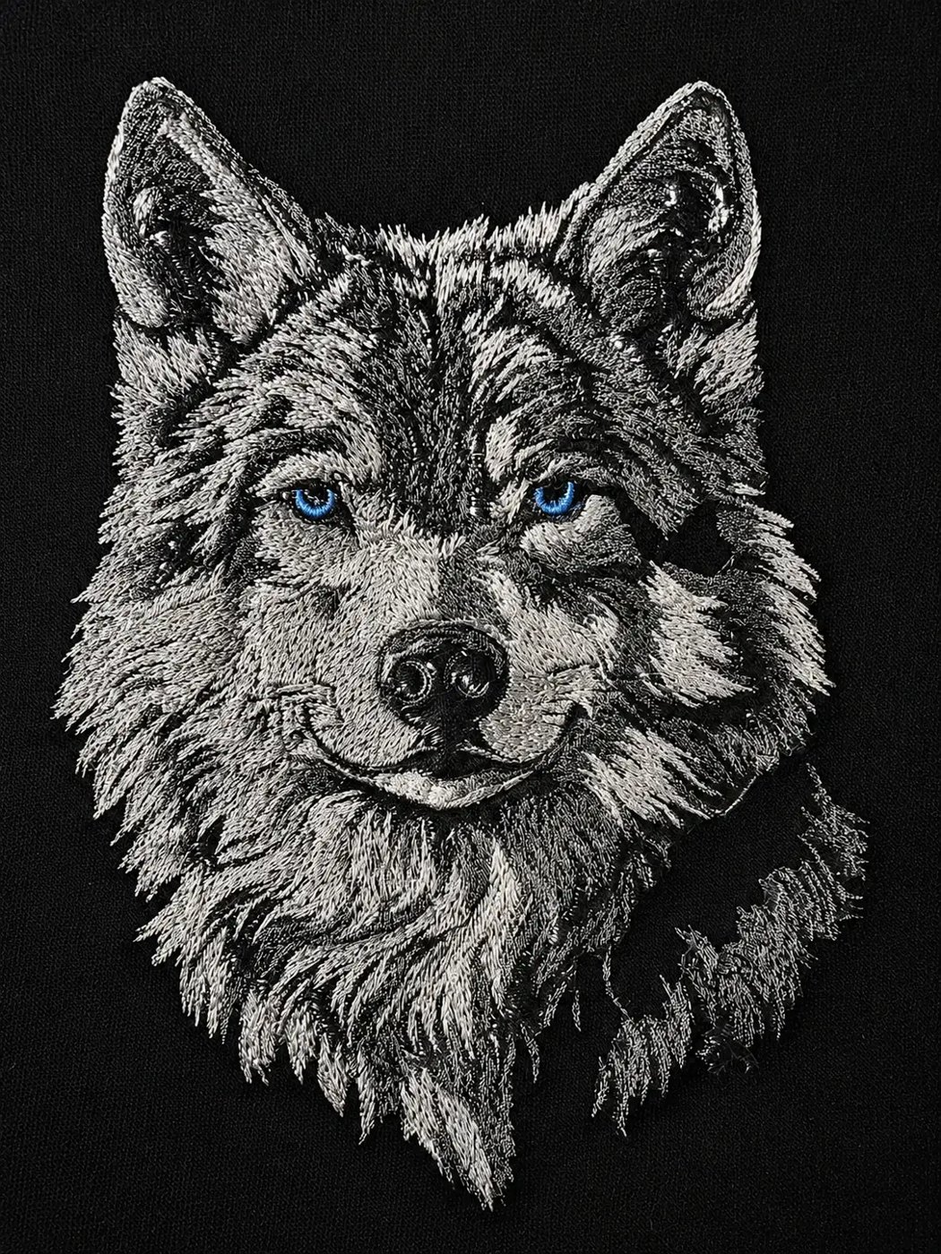 Detailed wolf embroidery on black — custom work by Ravage Designs