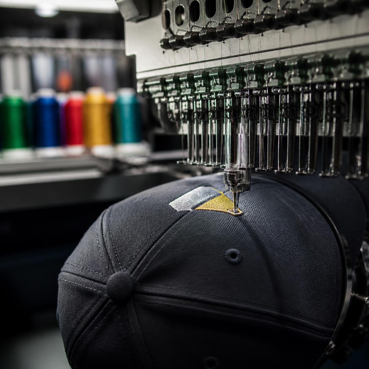 Embroidery machine stitching a custom hat